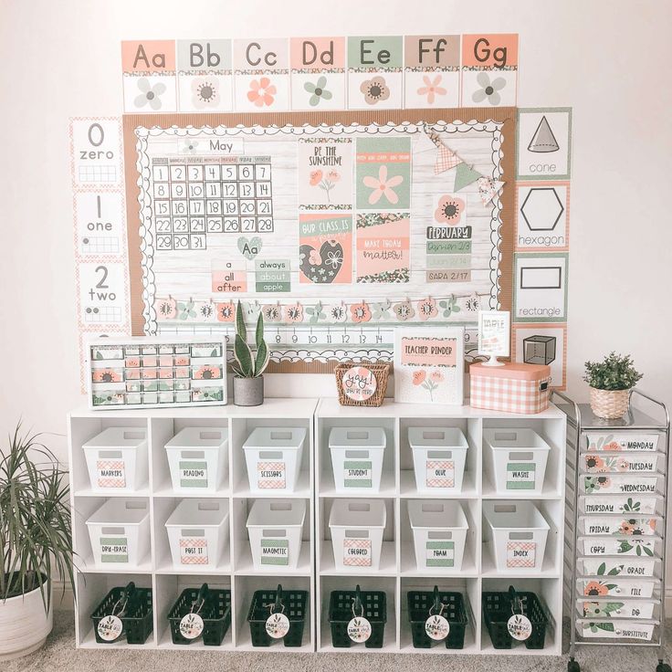 a white shelf filled with lots of bins next to a wall mounted calendar on the wall