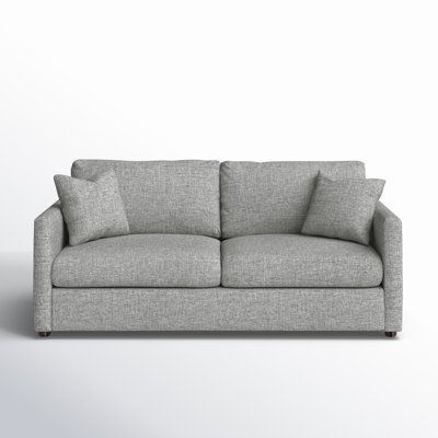 a gray couch sitting on top of a white floor