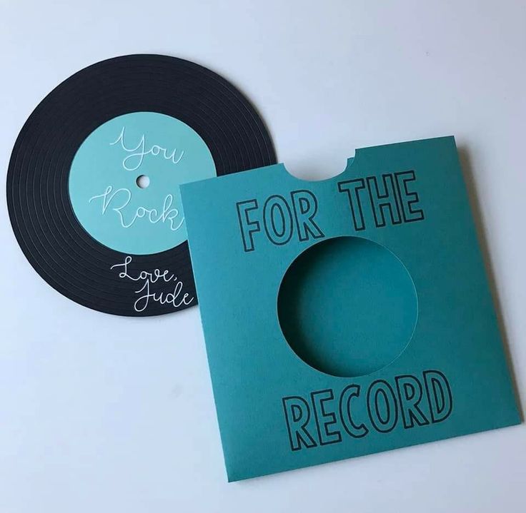 two records with the words for the record printed on them, one black and one teal