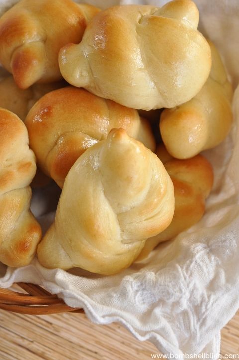 some bread rolls in a basket on a table