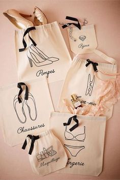 four personalized tote bags with shoes and bras on the bottom one is pink