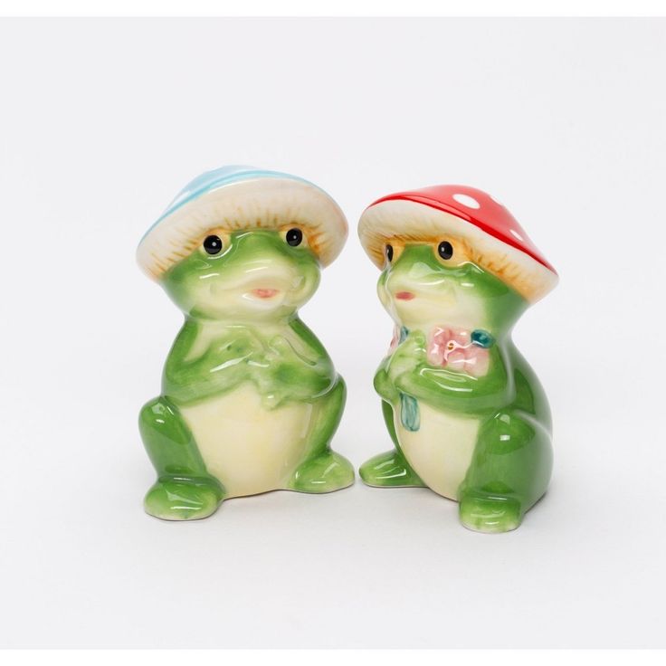 two small ceramic figurines sitting next to each other