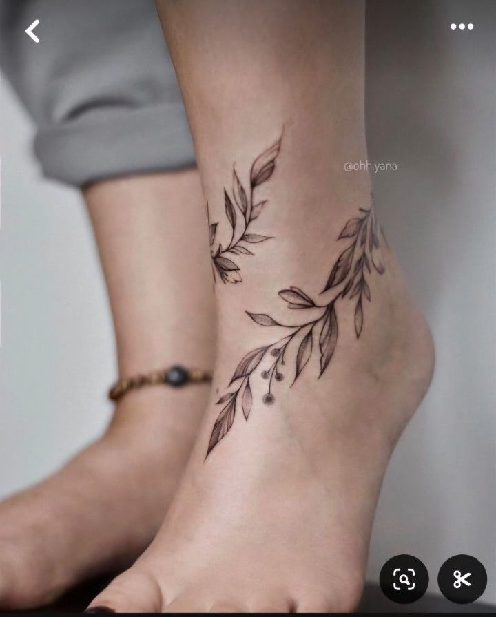 a woman's foot with leaves on it