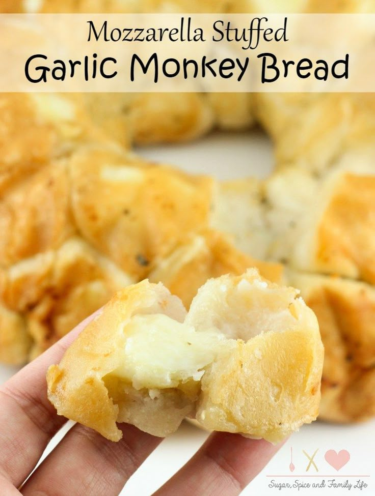 a hand holding a piece of garlic monkey bread in front of the camera with text overlay