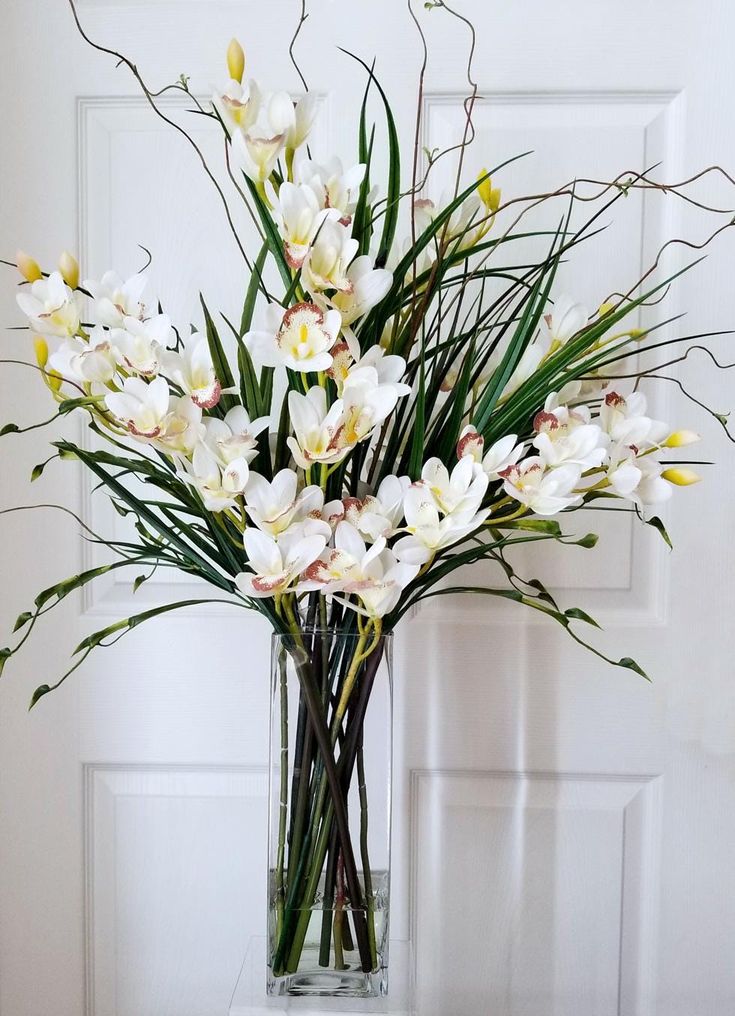 a vase filled with white flowers on top of a table