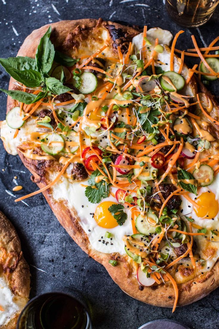 a pizza topped with veggies and cheese on top of a table