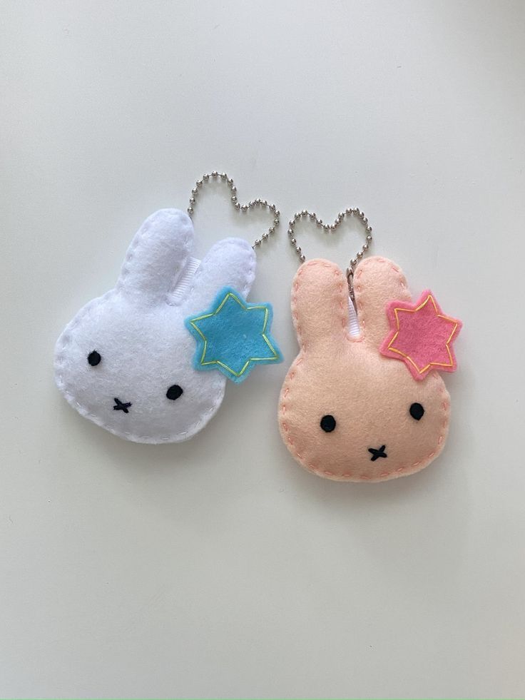 two keychains shaped like bunnies with stars on them