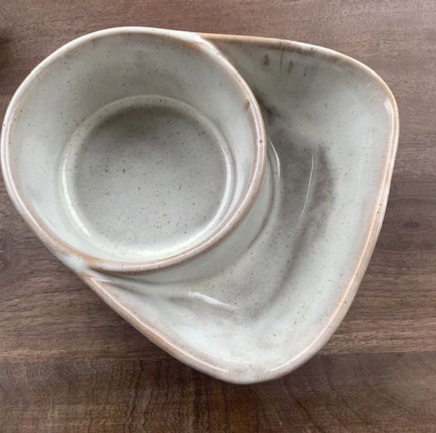 two white bowls sitting on top of a wooden table