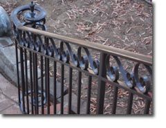 a fire hydrant sitting next to a metal fence