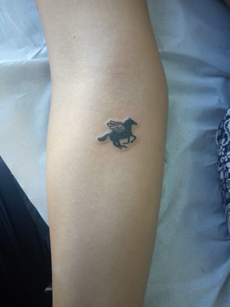 a person with a small tattoo on their arm