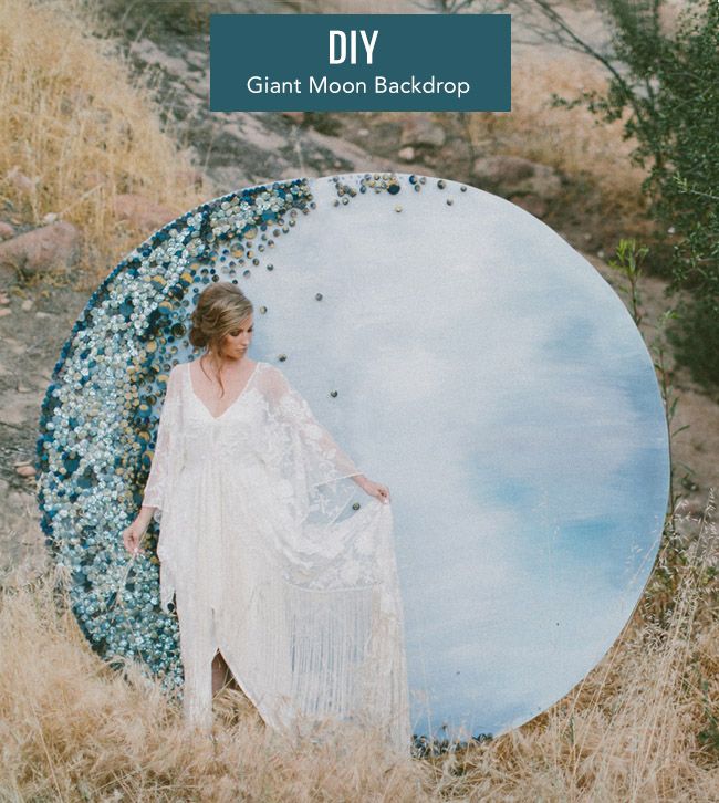 a woman standing in front of a mirror with the words giant moon backdrop on it