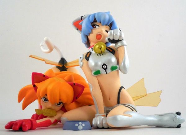 two anime figurines sitting next to each other