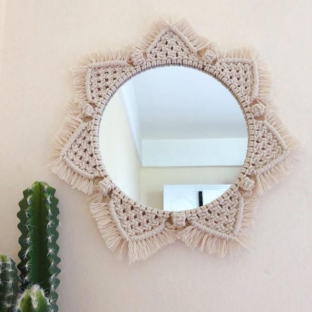 there is a mirror on the wall next to a cactus