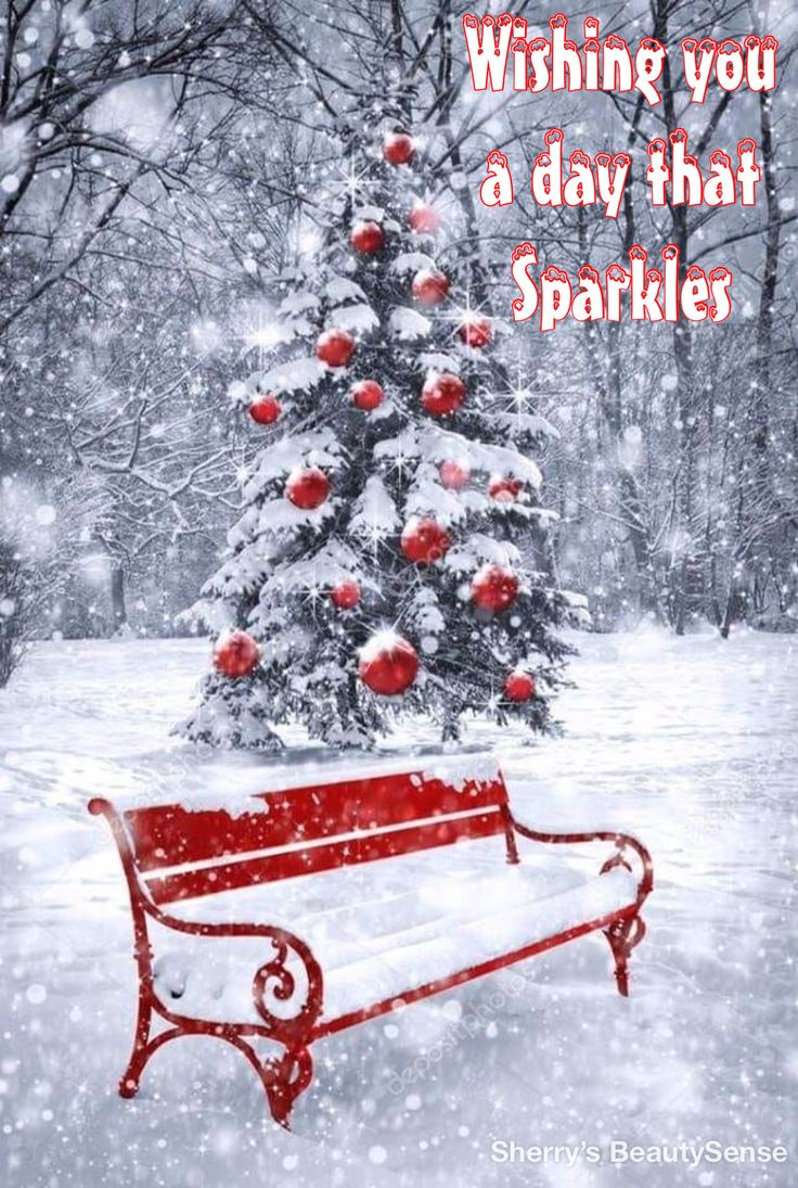 a red bench sitting in front of a christmas tree