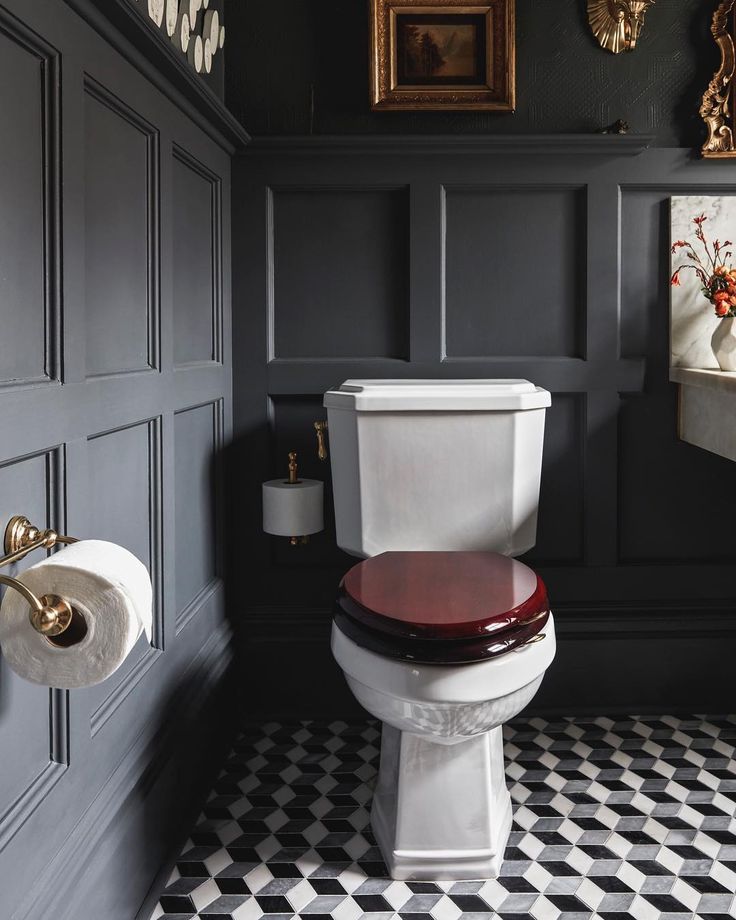 a white toilet sitting in a bathroom next to a black wall