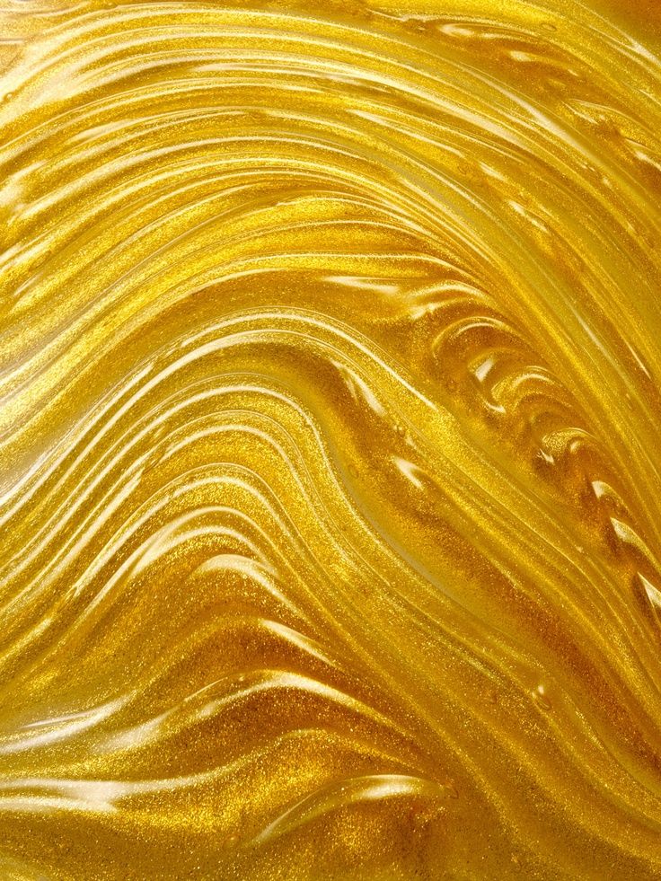 the texture of yellow liquid is shown in this close up photo, which appears to be wavy lines