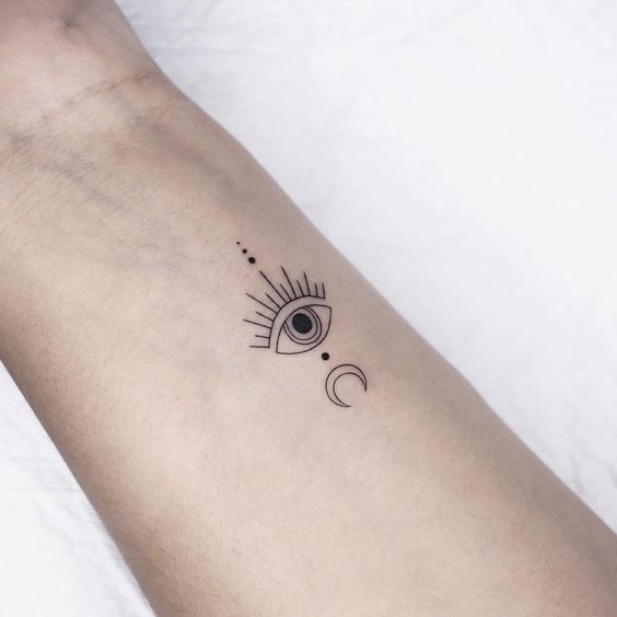 a woman's arm with an eye tattoo on it