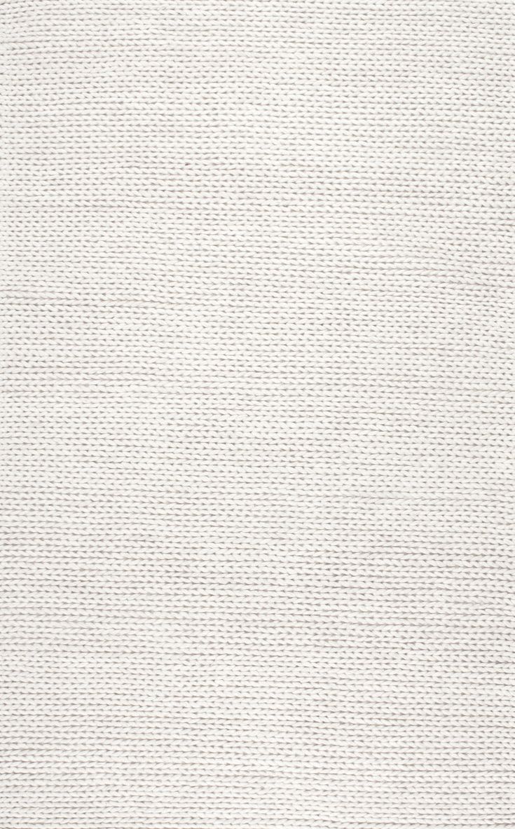 a white rug with small squares on it