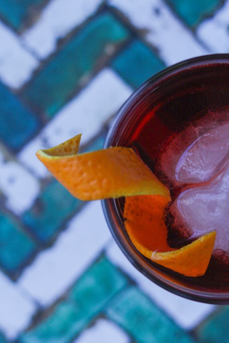 an orange peel on the rim of a drink