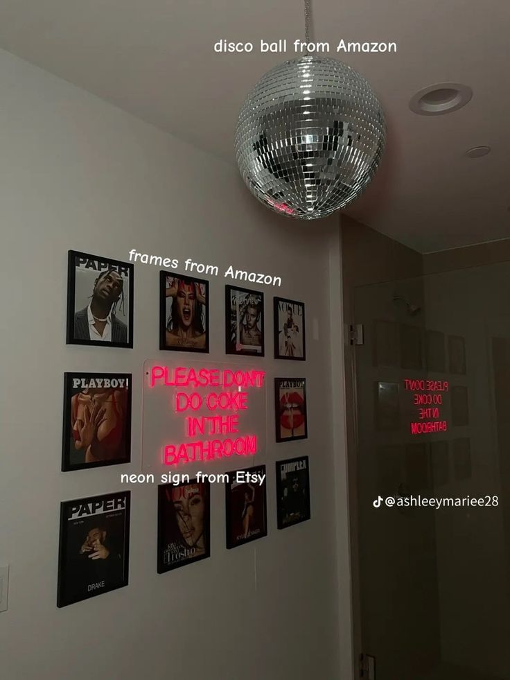 there is a disco ball hanging from the ceiling in front of pictures on the wall