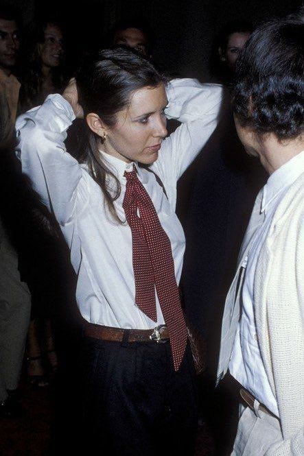 two people standing next to each other wearing ties