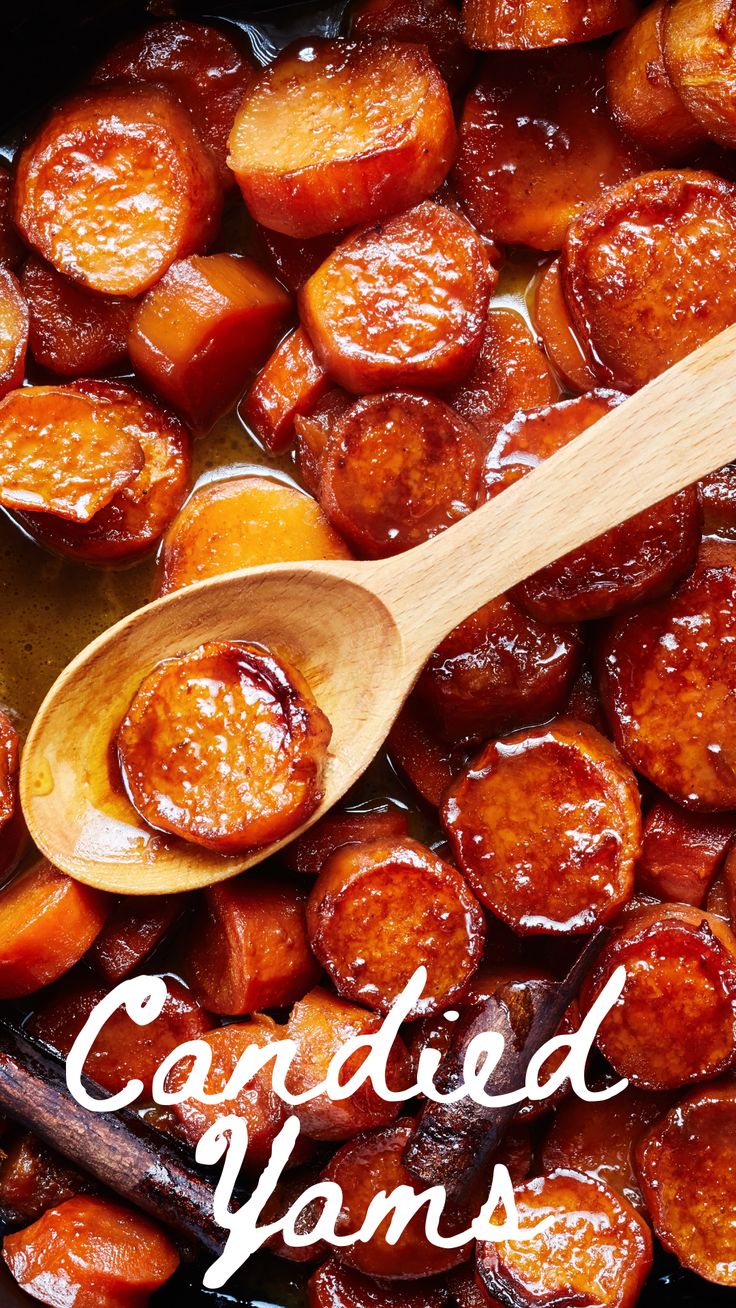 cooked carrots in a pan with a wooden spoon and title that reads candied yams