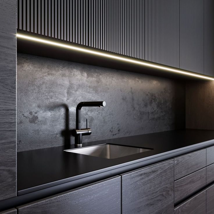 a kitchen with black counter tops and wooden cabinets, along with a stainless steel faucet