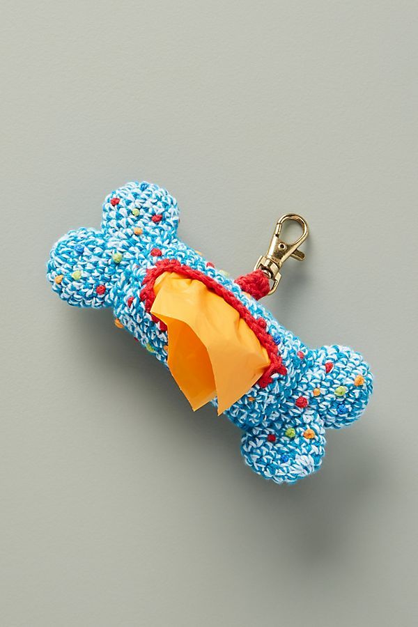 a blue dog toy with an umbrella attached to it's side on a gray surface