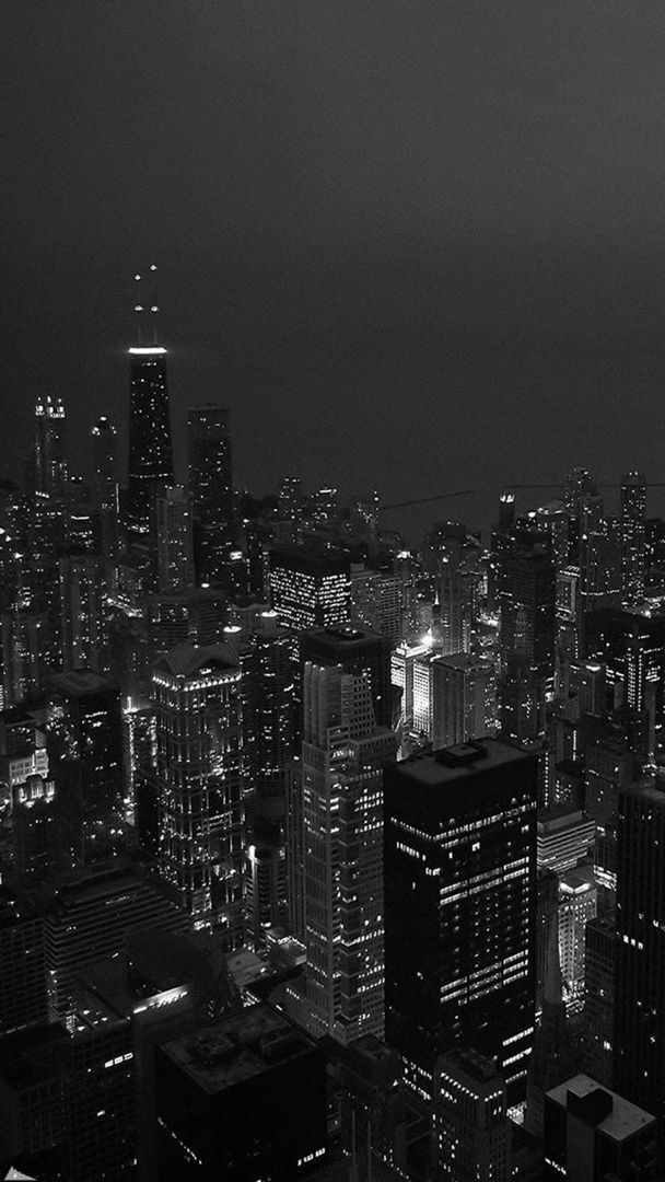 black and white cityscape at night with skyscrapers in the foreground, new york city