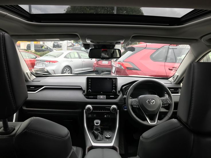 the interior of a car with several cars in the background