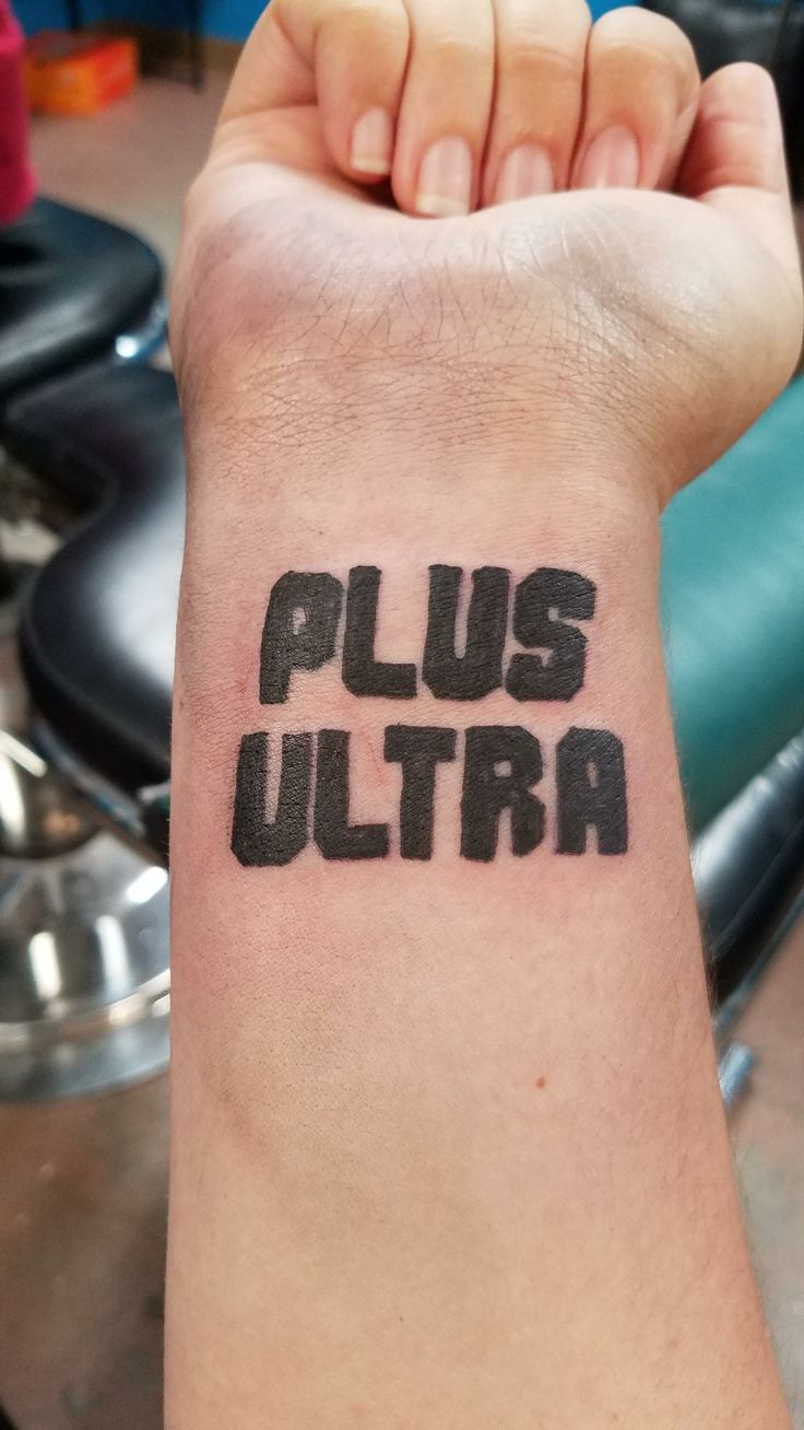 a person with a tattoo on their arm that says, plus ultra in black ink