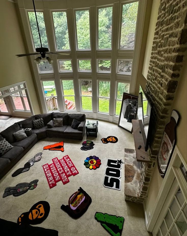 a living room filled with furniture and lots of stickers on the floor in front of a large window