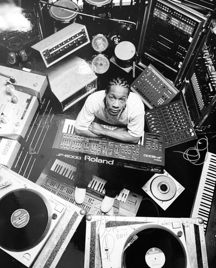 a man is surrounded by many electronic equipment