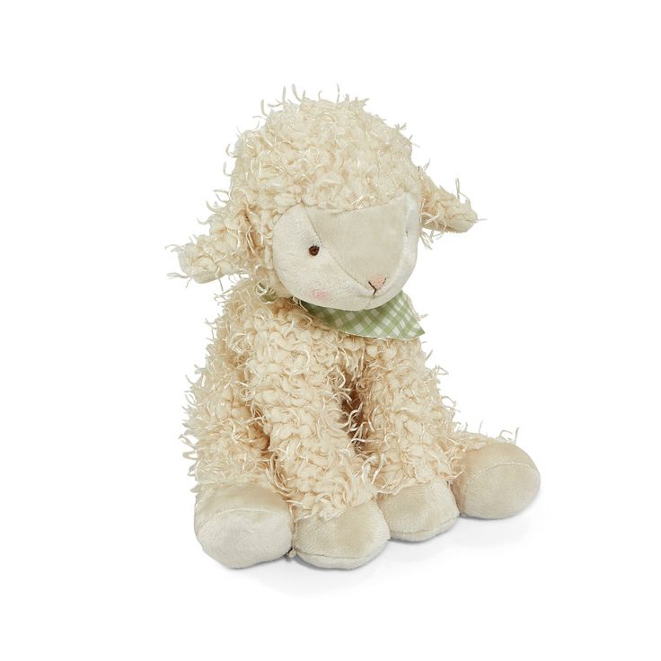 a white stuffed sheep with a green bow on its neck sitting against a white background