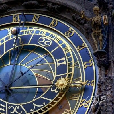 a close up of a clock on the side of a building with roman numerals