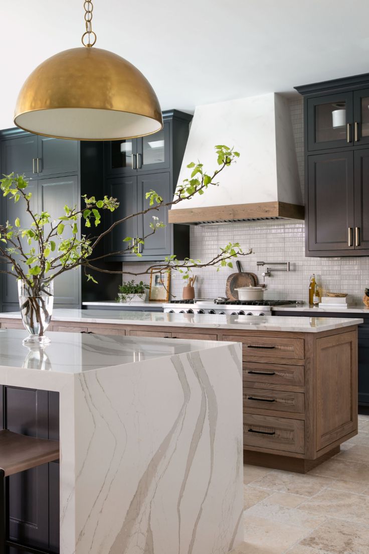 the instagram page is showing an image of a kitchen with black cabinets and white counter tops