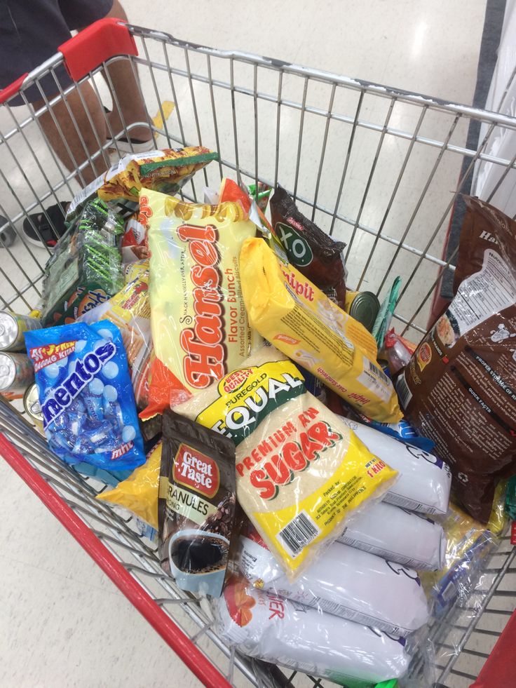 a shopping cart filled with snacks and condiments