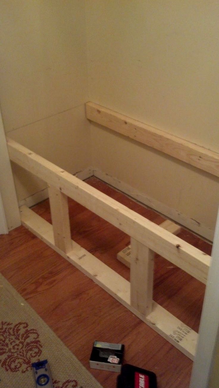 a wooden bench sitting on top of a hard wood floor