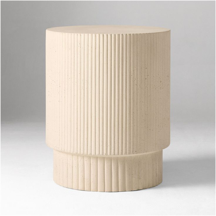 a white vase sitting on top of a table