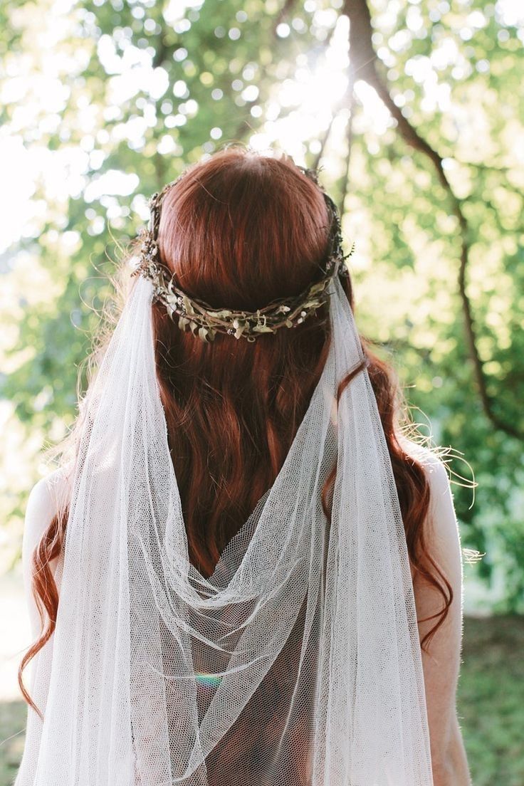 a woman with red hair wearing a veil