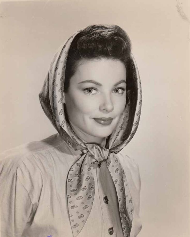 black and white photograph of a woman wearing a hood