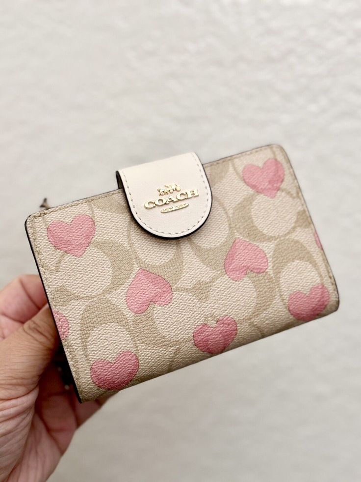 Coach Medium Corner Zip Wallet In Signature Canvas With Heart Print Brand new with tags 100% Authentic Limited Edition Color: Gold/Light Khaki Chalk Multi Product Details Signature coated canvas and smooth leather Seven credit card slots Bill compartment ID window Snap closure Zip coin pocket 5" (L) x 3 1/2" (H) x 1/2" (W) Style No. CQ146 Original Packaging! Same day shipping Small Coach Purse, Cute Coach Wallet, Cherry Coach Wallet, Coach Snap Wallet, Coach Wallet Keychain, Pink Coach Wallet, Wallets Aesthetic, Keychain Wallets, Window Snap