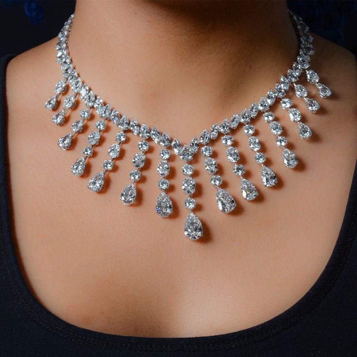 a woman wearing a diamond necklace on her chest