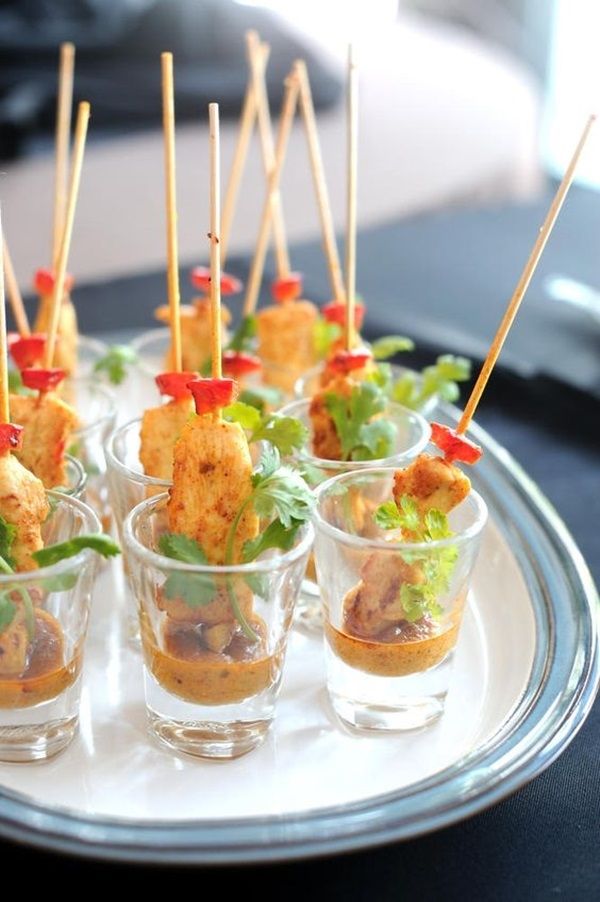 there are many appetizers in small cups on the plate