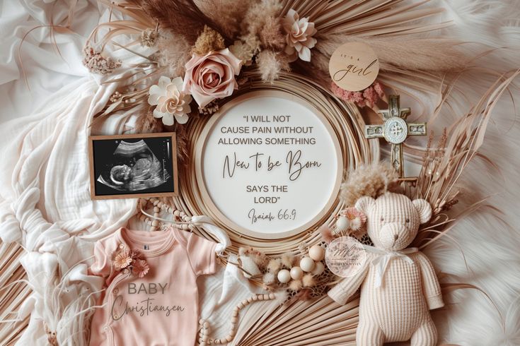 a baby announcement surrounded by items such as a teddy bear, flowers and other things