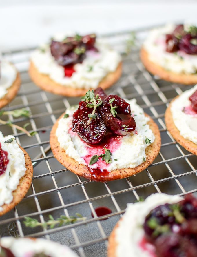 small cranberry and goat cheese appetizers on a cooling rack next to a bottle of breaton