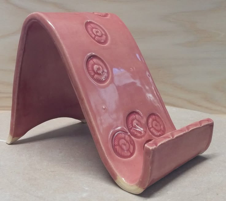 a pink ceramic object sitting on top of a table