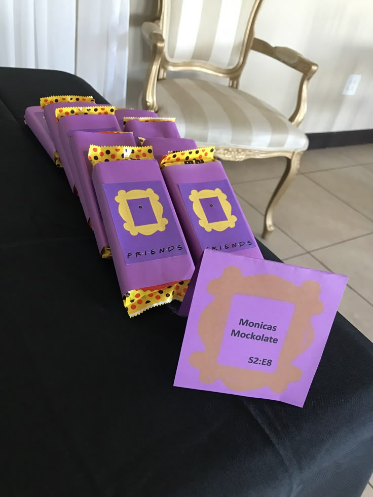 purple and yellow candy bags sitting on top of a table