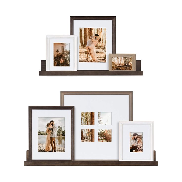 three wooden frames with pictures hanging on the wall