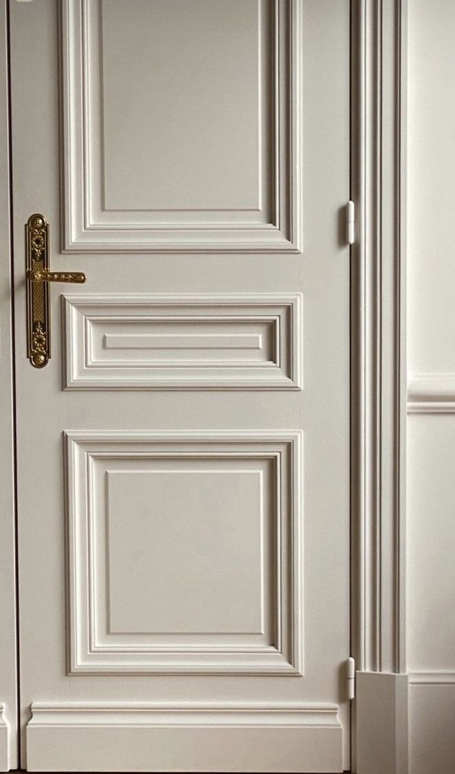 the door is white and has gold handles